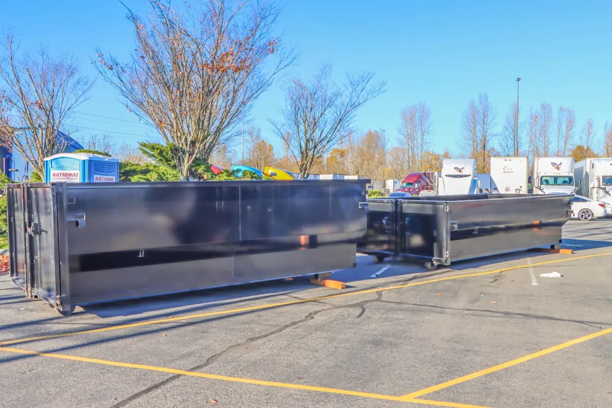 Professional dumpster rental service with roll-off container on residential driveway in Fort Oglethorpe